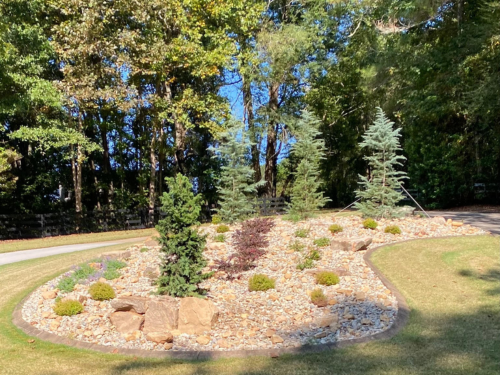 Eample of layed out sod and freshly packed dirt with hardscaped retaining wall